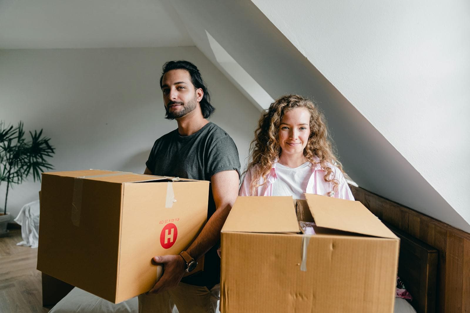 People carrying moving boxes after a real estate appointment